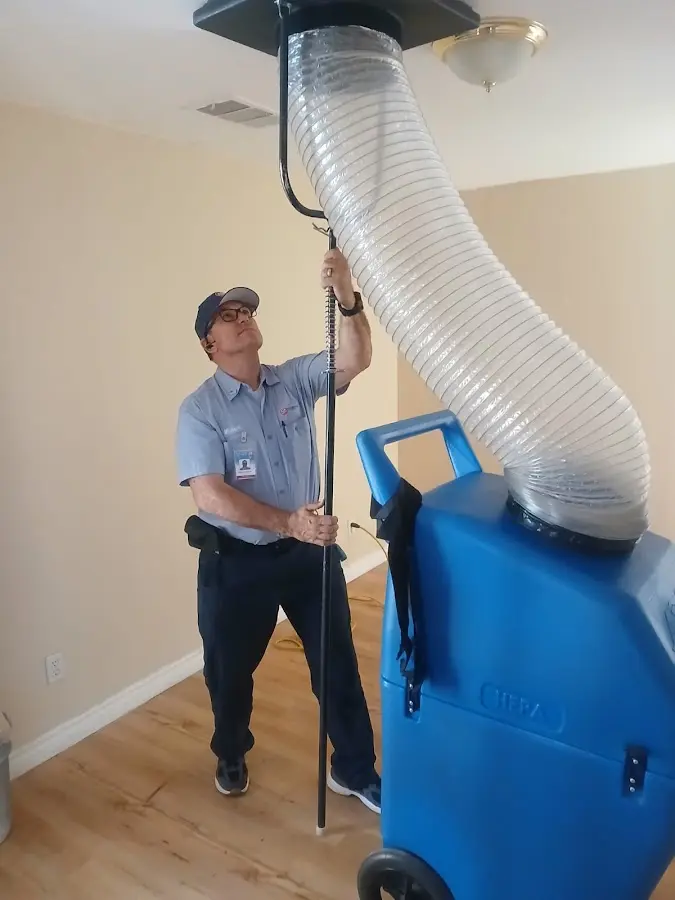 Furnace Tune-Up technician using HEPA equipment in Putnam